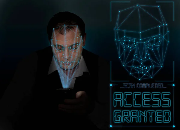 Biometric verification - young man face recognition unlocking smartphone