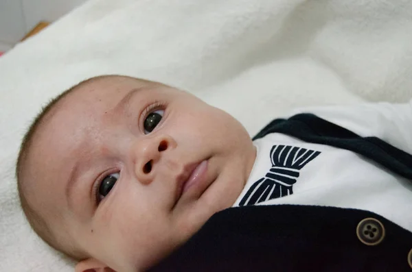 Beyaz Bebek Değiştirici Üzerinde Döşeme Işadamı Ile Papyon Yüz Minderlerle — Stok fotoğraf