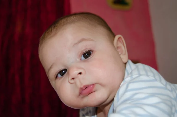 Carino 4 mesi vecchio bambino avendo pancia tempo e fare divertente facce — Foto Stock