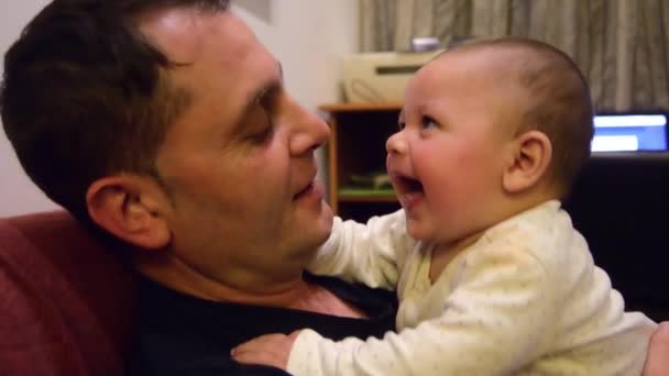 Father and his cute six months old baby boy cuddling and speaking, spending some quality time together — Stock Video