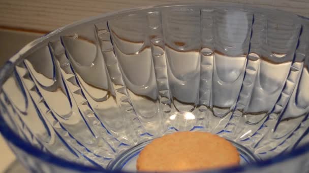 Woman hand taking last cookie buiscut from blue glass bowl — 비디오