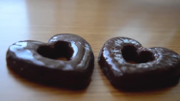 Två hjärtformade kex på trä bordet — Stockvideo