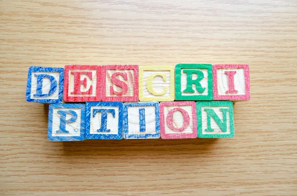 Educational toy cubes with letters organised to display word DESCRIPTION - editing metadata and Search engine optimisation concept