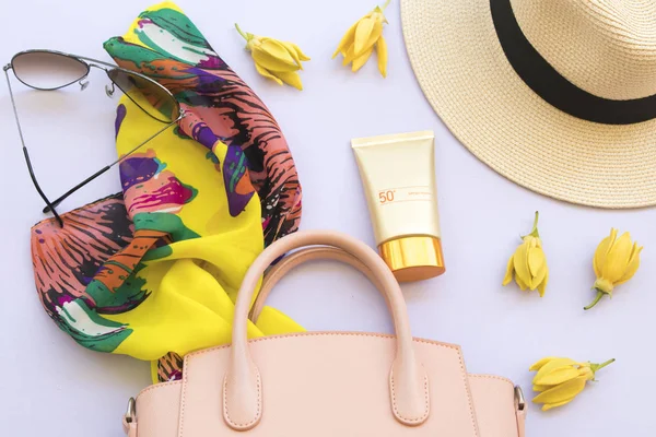 sunscreen spf50 ,pink bag,hat and yellow scarf accessories of lifestyle woman relax on background white