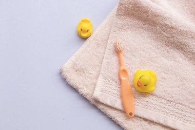 Bebek ve havlu kumaş sağlık için bebek banyo üzerinde arka plan beyaz diş fırçası