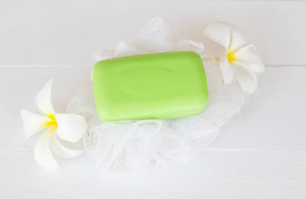 herbal soap for health care body skin with white  flower frangipani on background white wooden