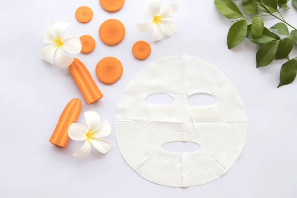 natural aroma sheet mask for skin face from herbal carrot essence face mask on background white