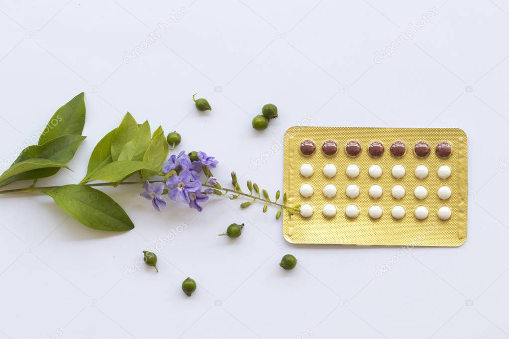 birth control pills contraceptives woman for do not want to have baby  with purple flowers decoration flat lay style on background white 