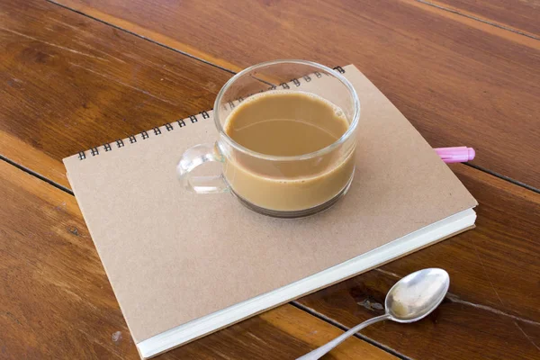 notebook planner  for business work with hot coffee at office desk