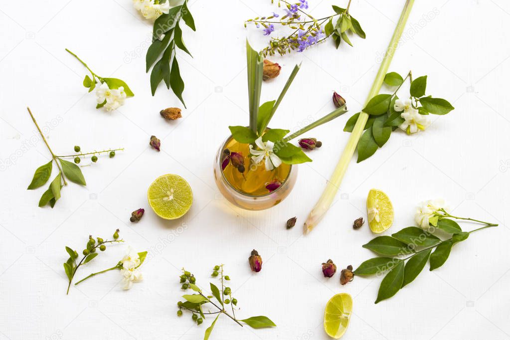 natural herbal healthy drink for cough sore mix rose tea ,lemon arrangement flat lay style with flower jasmine ,lemon slice  on background white