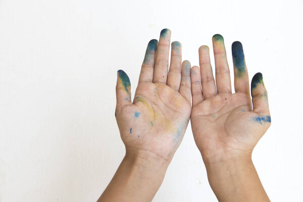 hand of girl dirty color open on background white wooden 