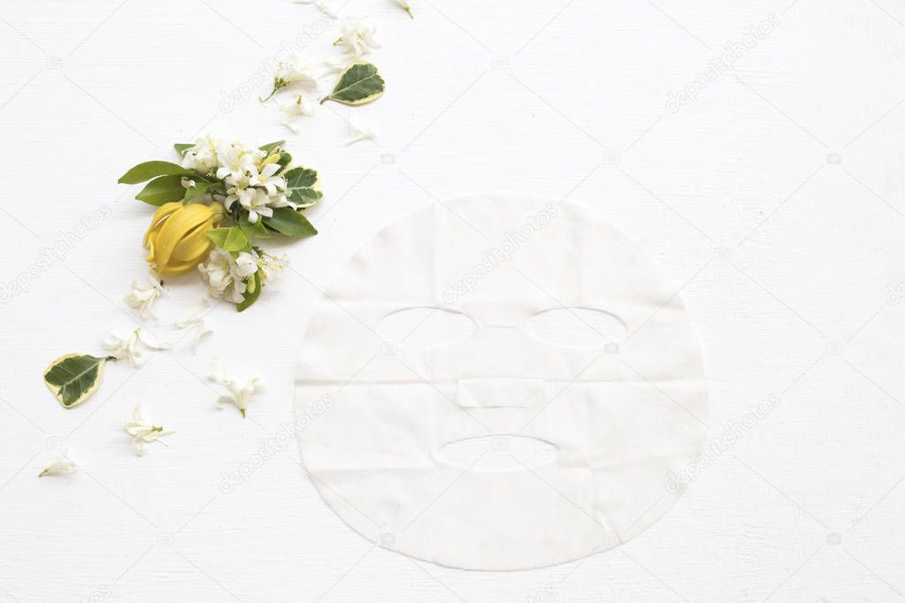 natural aroma sheet mask extract flowers essence face mask health care for skin face with flowers ylang ylang ,jasmine arrangement flat lay style on background white