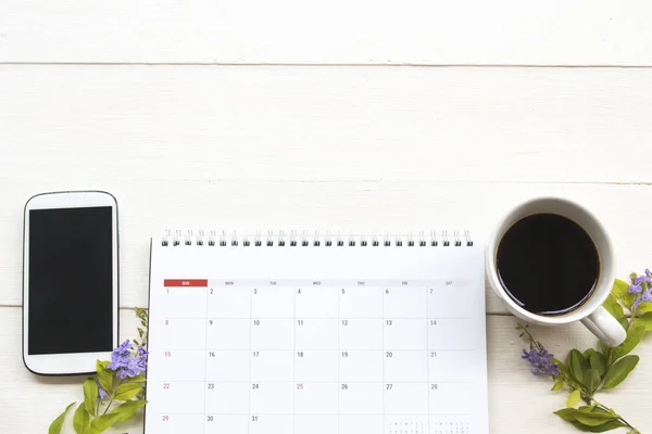 calendar planner ,mobile phone and hot coffee of lifestyle at office arrangement flat lay style on background white