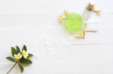 Doğal kozmetik bitkisel aroma maskesi, yatıştırıcı jöle, toner serumu ve cilt sağlığı hizmetleri için pamuk yüz maskesi. Kış mevsiminde hayat tarzı kadınının maskesi. Çiçekli beyaz Frangipani. 