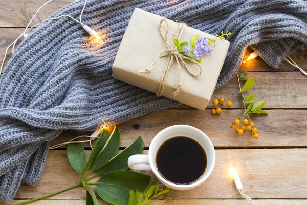 gift box for special day in festival day christmas and new year with hot coffee ,knitting wool scarf of lifestyle woman in winter season arrangement flat lay style on background wooden