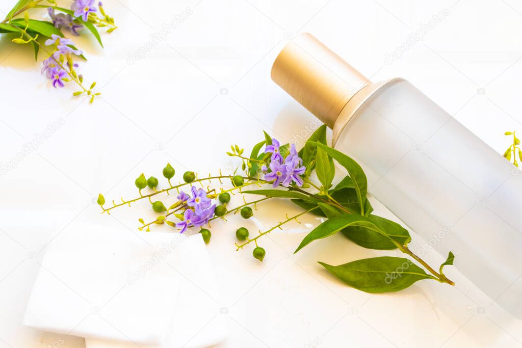 the therapy first serum toners with cotton natural cosmetics extract herbal health care for skin face beauty of woman and purple flowers arrangement flat lay style on background white 