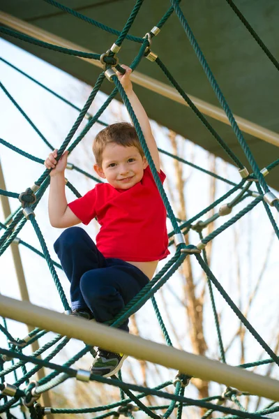 Mignon Jeune Garçon Jouer Sur Aire Jeux Image En Vente