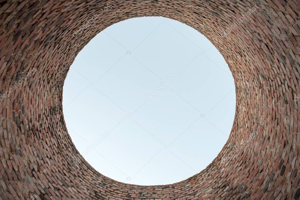 bottom view of sky through red brick chimney