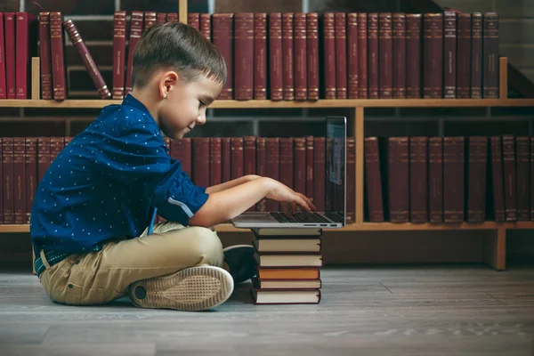 Boy with laptop and books — Stock Photo, Image