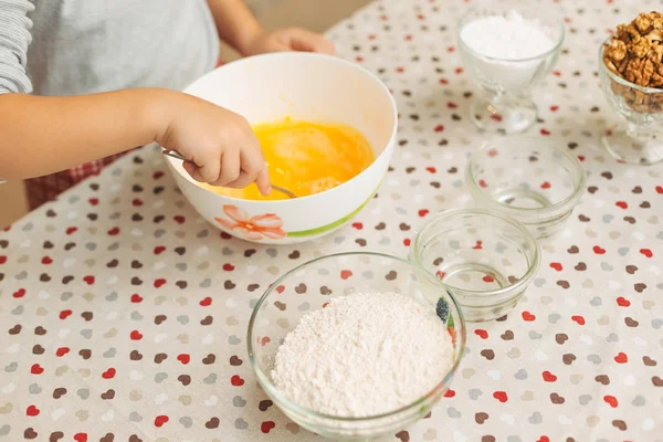 Close-up boy hands mixing the ingredients while cooking — Stock Photo, Image