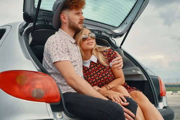 Paret sitter i bilen stammen drömmer medan du tittar på himlen — Stockfoto