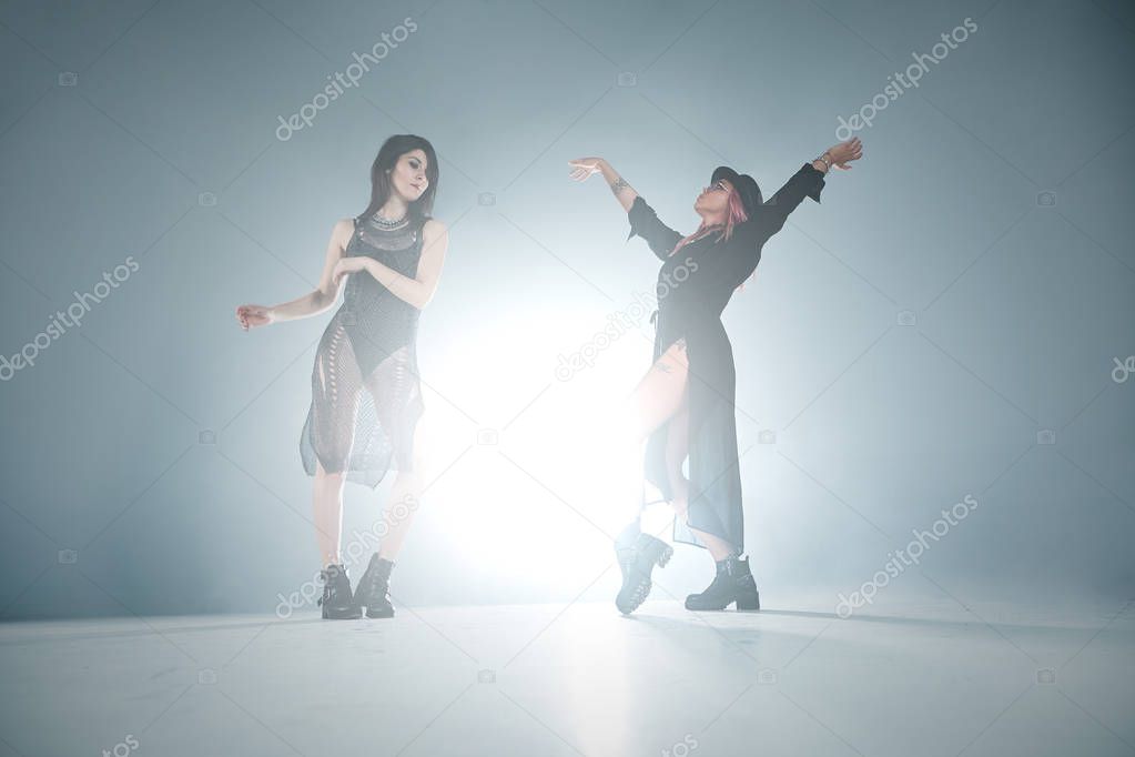 Dancing girls moving in fume and lights  