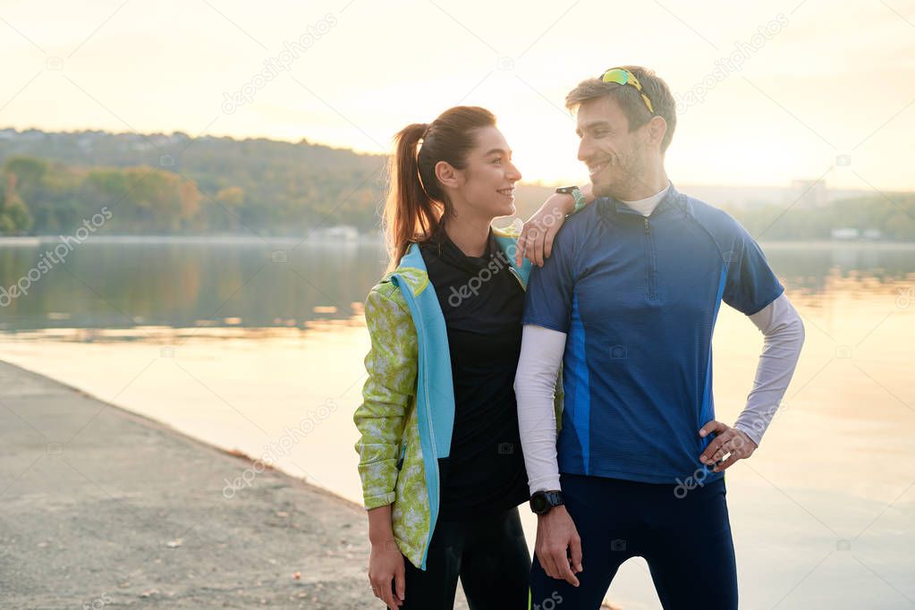 Sport motivation and healthy fitness lifestyle. Young couple of runners resting during outdoor morning workout.