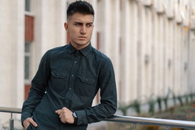 Yakışıklı bir genç casual adam sokak arka plan üzerinde poz portresi.