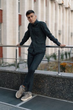 Yakışıklı bir genç casual adam sokak arka plan üzerinde poz portresi.