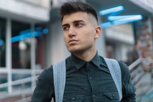 Portrait young man thinking of future on blurred city background