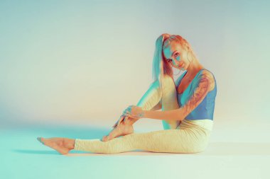 Atletik genç kadın yoga egzersizi yapıyor.