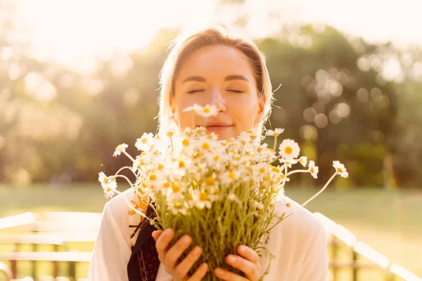 Hermosa mujer con flores de manzanilla — Foto de Stock