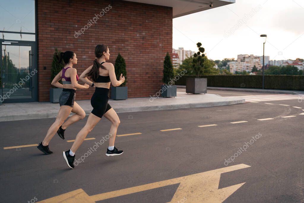 Women sprinting in the morning outdoors.