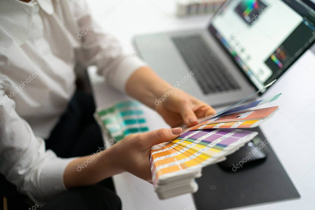 Woman hands working with color spctrum in the office