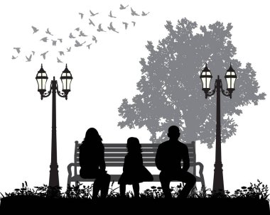 Park bankında oturan bir ailenin silueti.