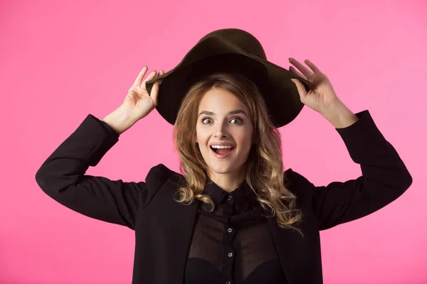 stock image beautiful young joyful girl in a black jacket and hat on a pink background