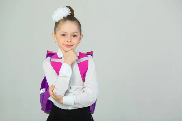 beautiful little girl with bow on head and with briefcase on white background