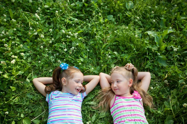 Two Little Beautiful Girls Lie Green Grass Summer Park — Stock Photo, Image