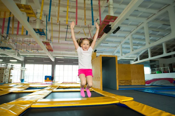 güzel küçük kız bir trambolin üzerinde kapalı atlama