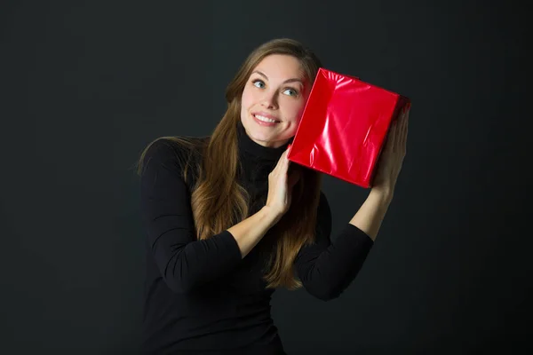 Schönes Junges Mädchen Mit Einem Geschenk Der Hand Auf Schwarzem — Stockfoto