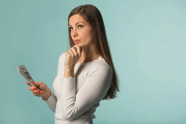 Beautiful Young Girl Considers Dollars Blue Background — Stock Photo, Image