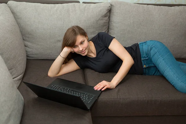 Beautiful Young Girl Black Shirt Lying Sofa Home Laptop Stock Image