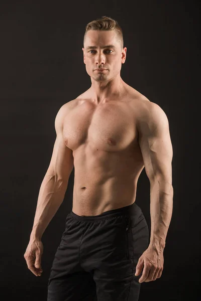 siyah arka plan üzerine yakışıklı kaslı adam