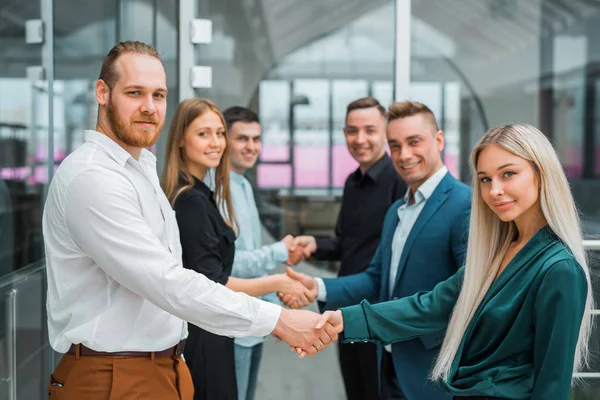 a team of specialist people hold hands at work