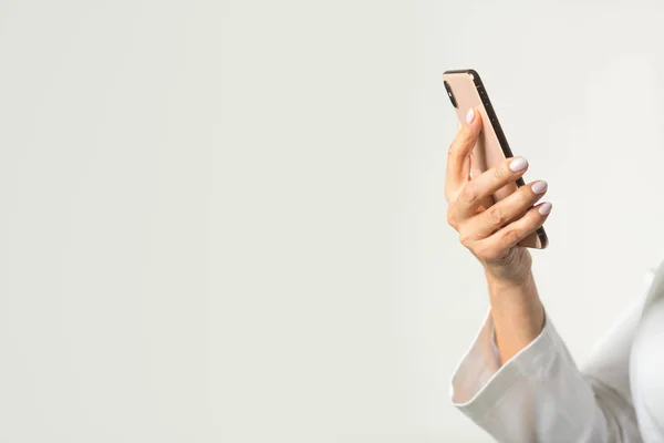 smartphone in the hand of a woman on a white background