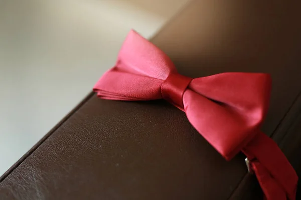 stylish red butterfly tie on the couch