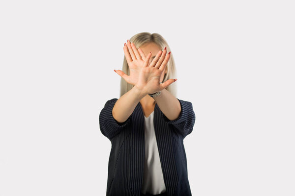 beautiful young woman in suit on white background with hand gesture