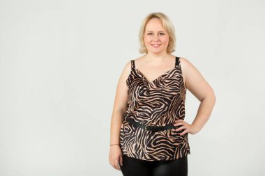 Güzel, genç, tombul bir kadın, beyaz bir arka planda.