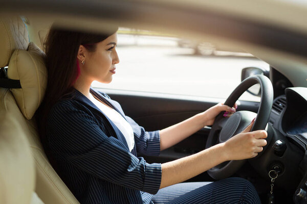 beautiful young woman driving a car