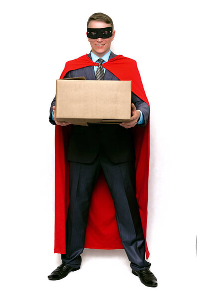 Delivery man super hero with cardboard box in hands isolated on white background. Delivery service concept.